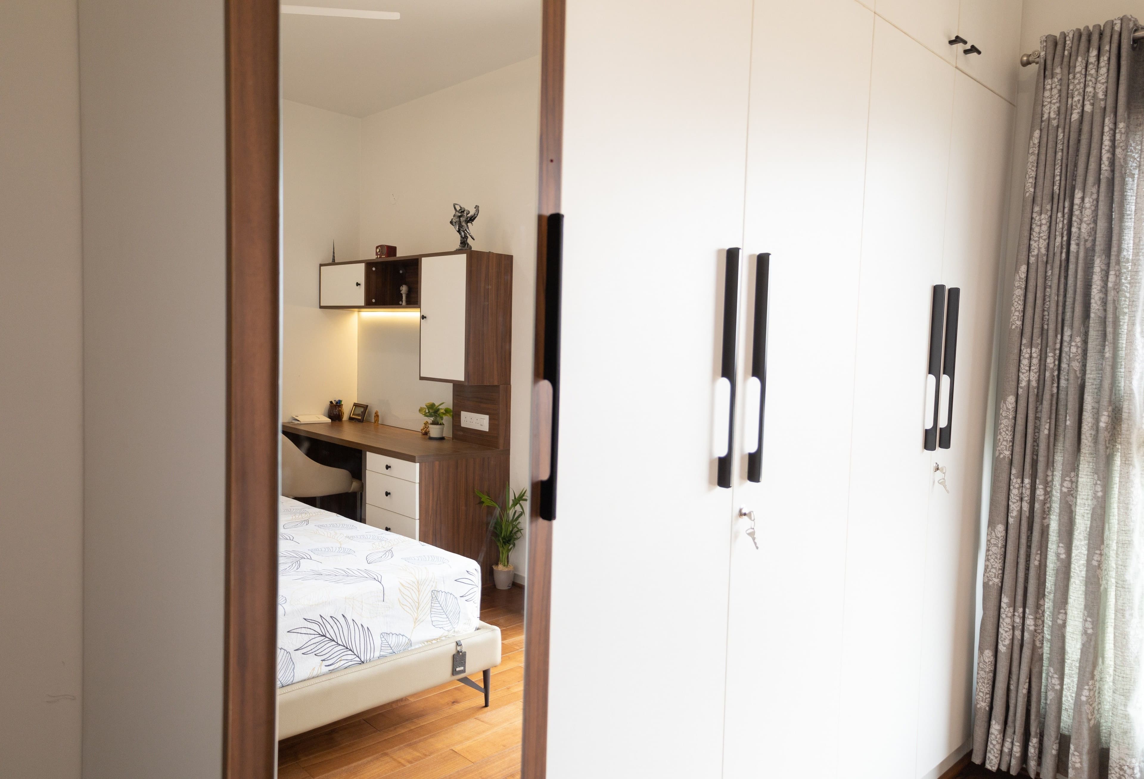 Bedroom with built-in wardrobe and full-length mirror